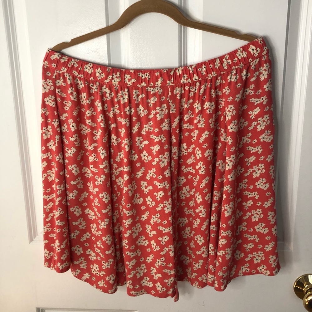 rose ish color skirt with white flowers